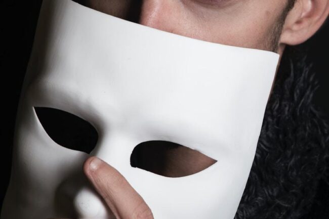 man with white face mask