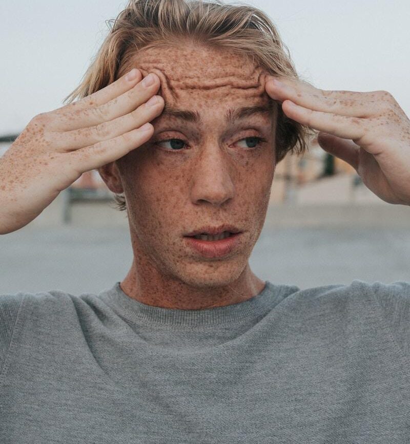 man in gray crew neck shirt with brown hair