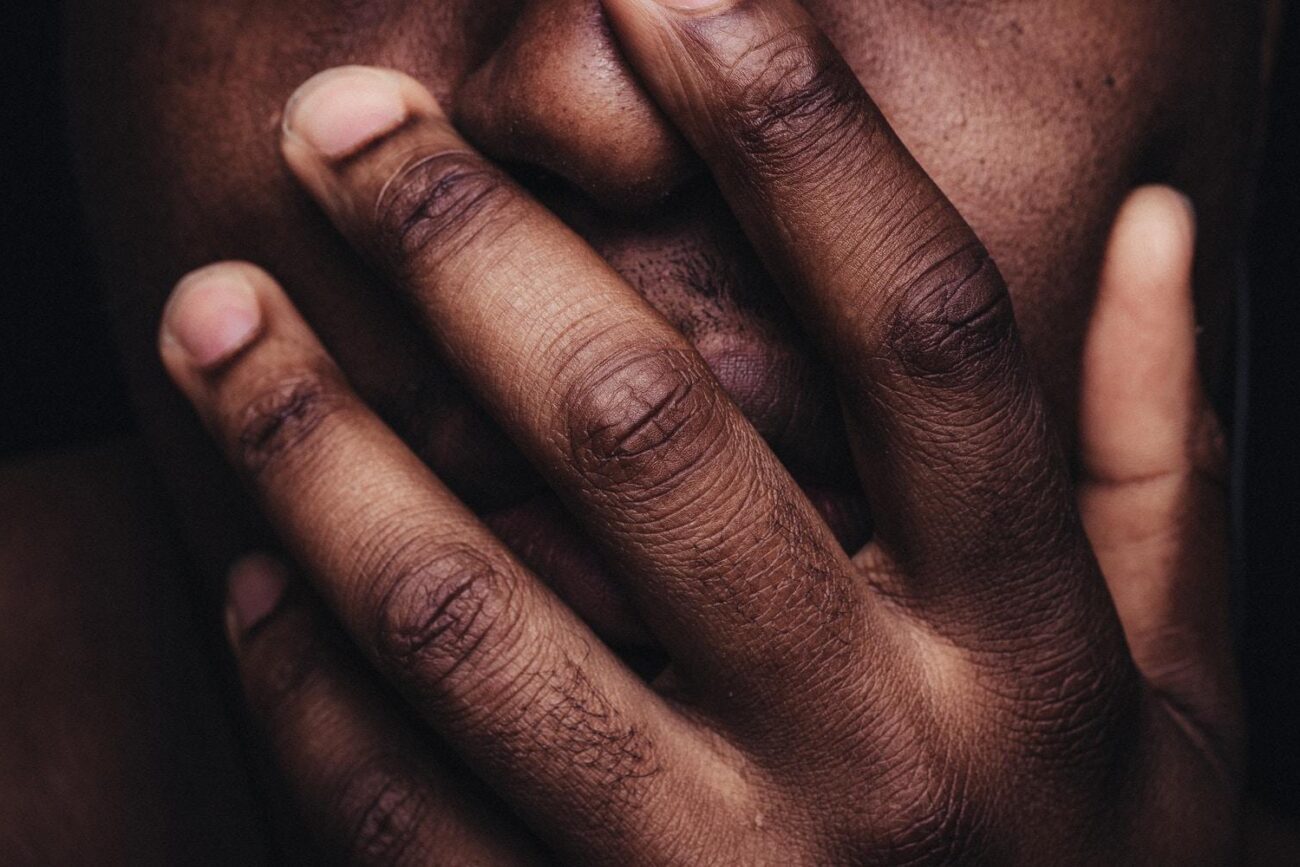 persons hand on his face